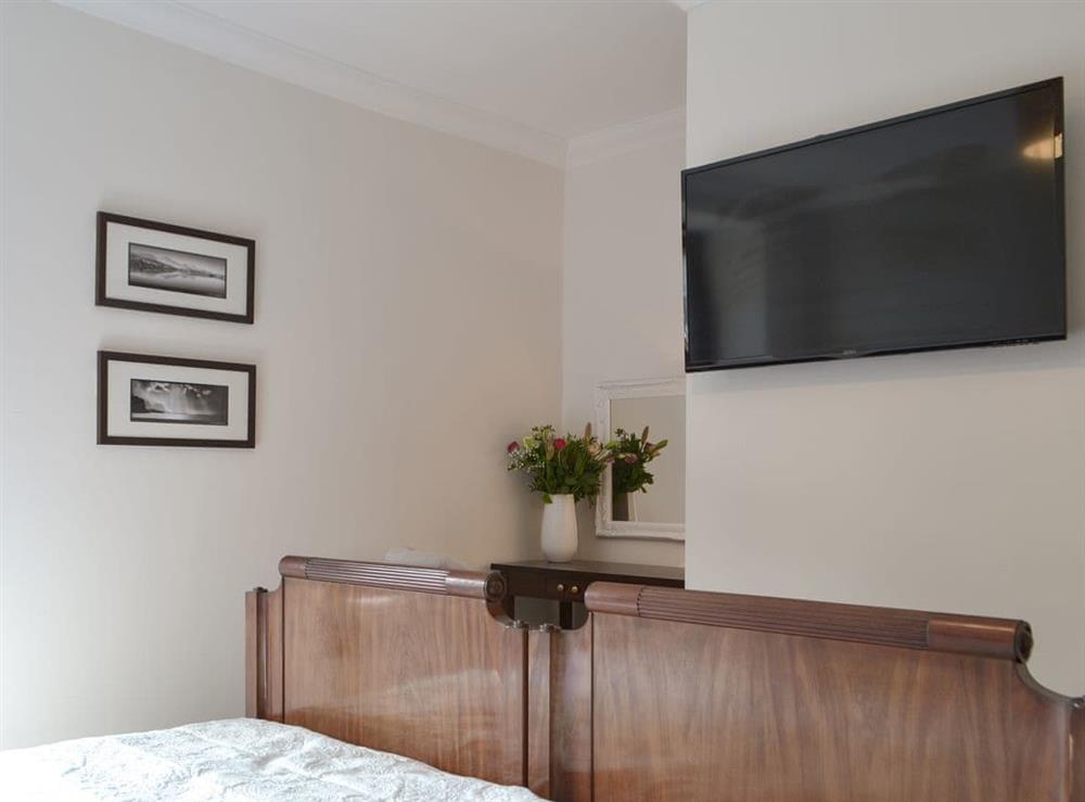 Double bedroom with wall mounted TV at Orrest View in Windermere, Cumbria