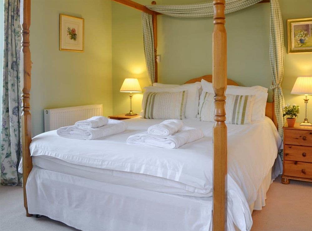 Attractive four poster bedroom at Osprey Cottage in Meigle, Perthshire., Great Britain