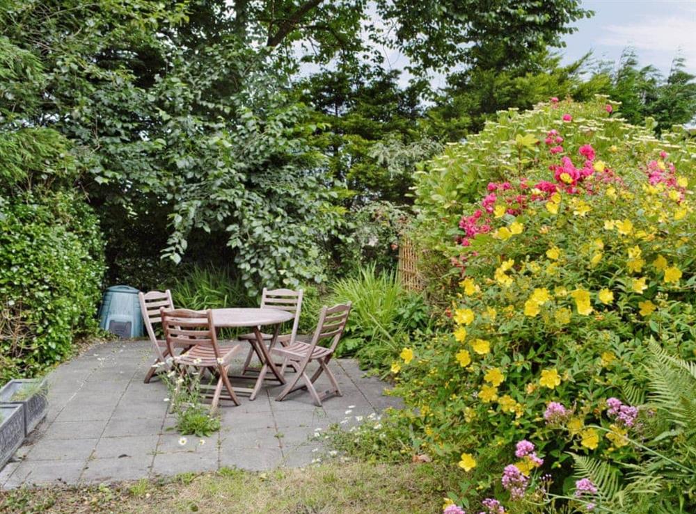 Secluded patio with garden furniture at Ostlers in Boscastle, Cornwall