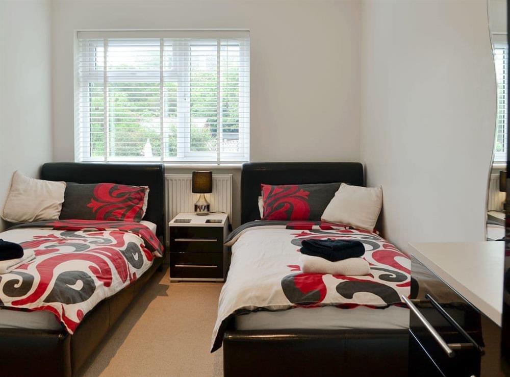 Colourful and cosy twin bedroom at Oswald House in Llanon, near Aberaeron, Dyfed