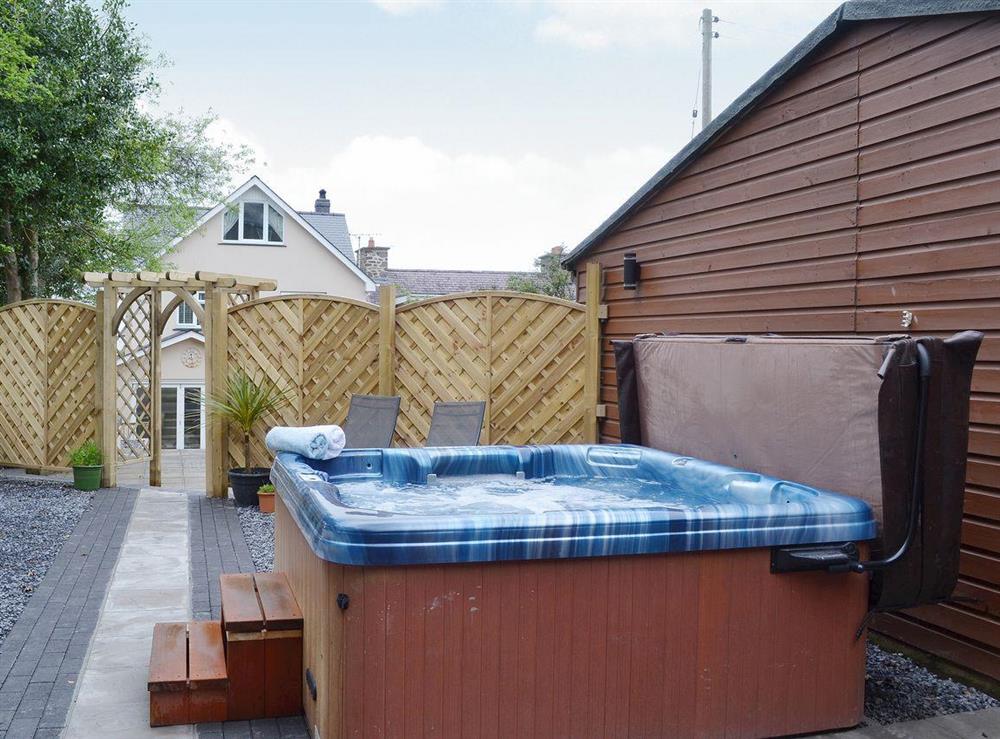 Relax in the private, secluded hot tub at Oswald House in Llanon, near Aberaeron, Dyfed