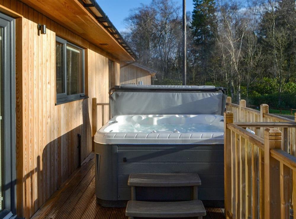Decked terrace with hot tub at Juniper Lodge, 