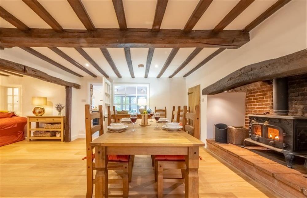 The dining area with beamed ceiling and inglenook fireplace at Owl Cottage, Great Snoring near Fakenham