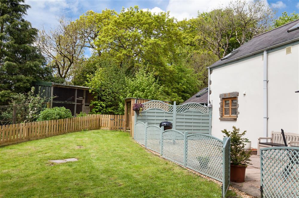 The garden, with a separate patio area, perfect for alfresco dining at Owl Cottage, Llanwrda
