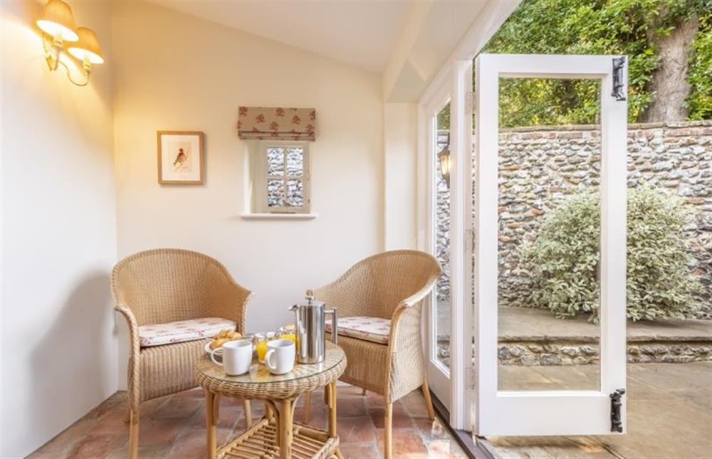French doors open to the courtyard garden at Owl Cottage, Stiffkey near Wells-next-the-Sea