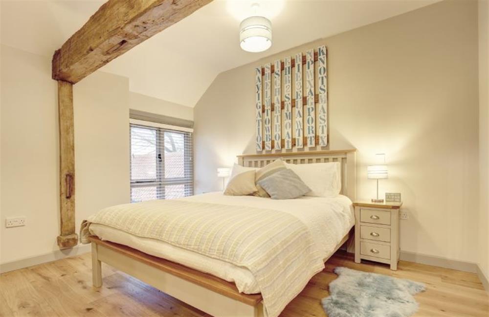 First floor: Bedroom two has king-size bed at Owlets at Mulberry Barn, Heacham near Kings Lynn