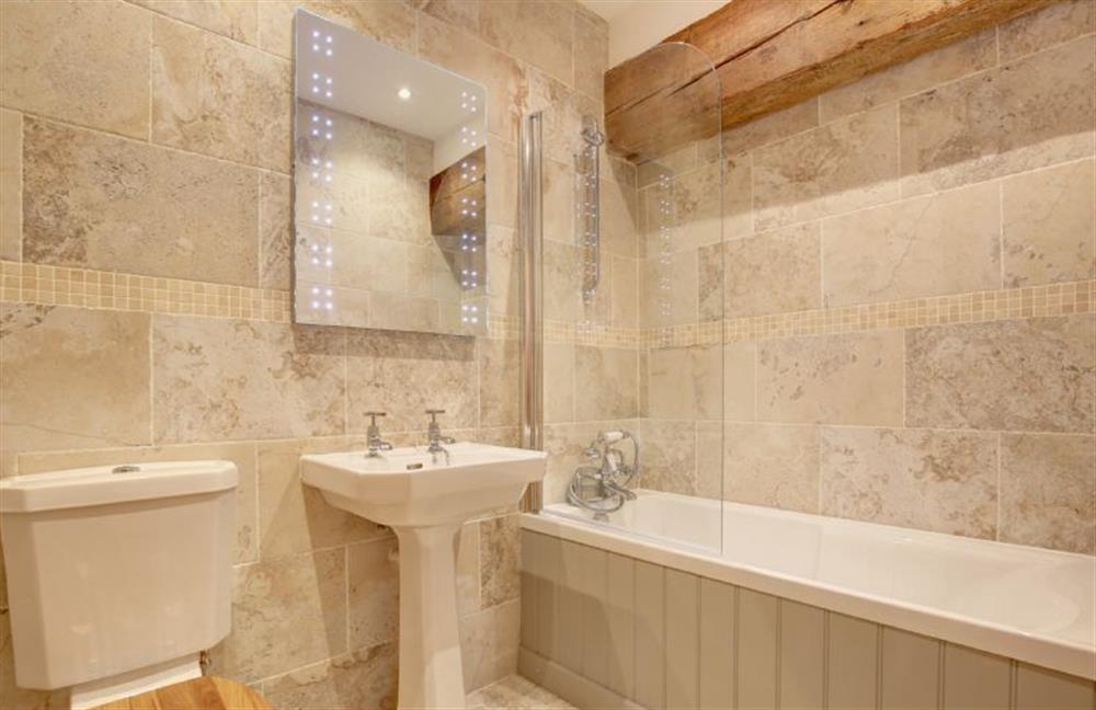 First floor: Family bathroom with hand-held shower over bath at Owlets at Mulberry Barn, Heacham near Kings Lynn