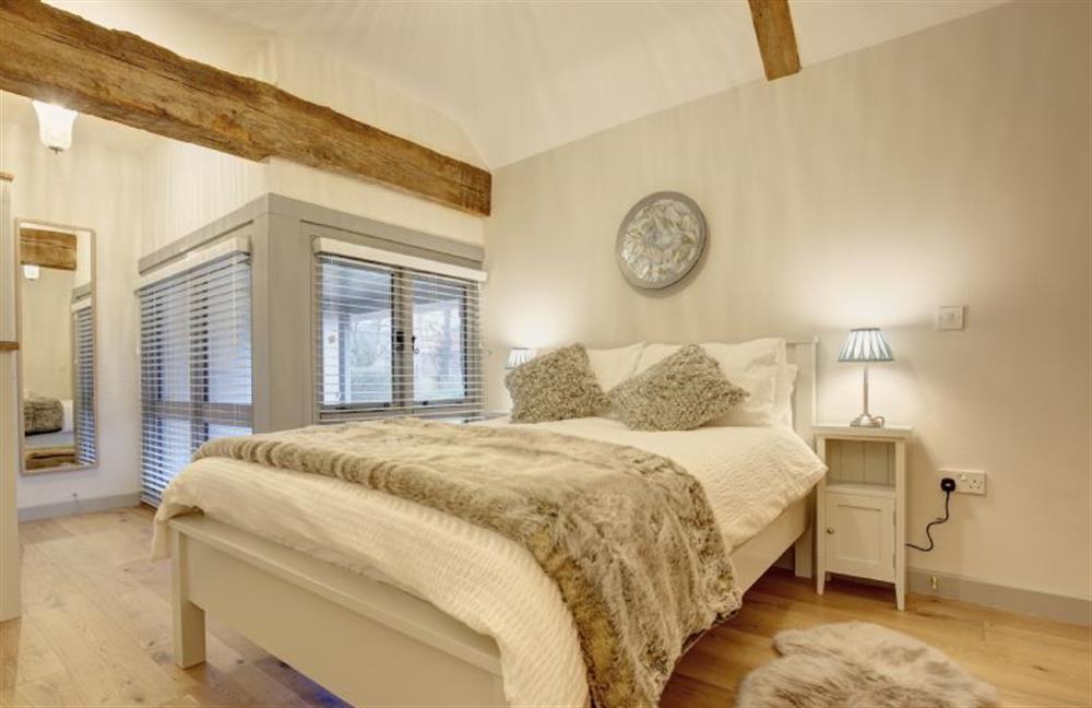 First floor: Master bedroom with double bed at Owlets at Mulberry Barn, Heacham near Kings Lynn