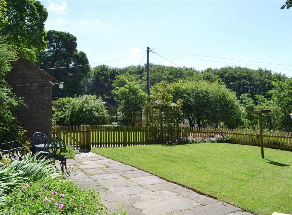Enclosed garden at Oxlow End Cottage in Peak Forest, Buxton, Derbyshire
