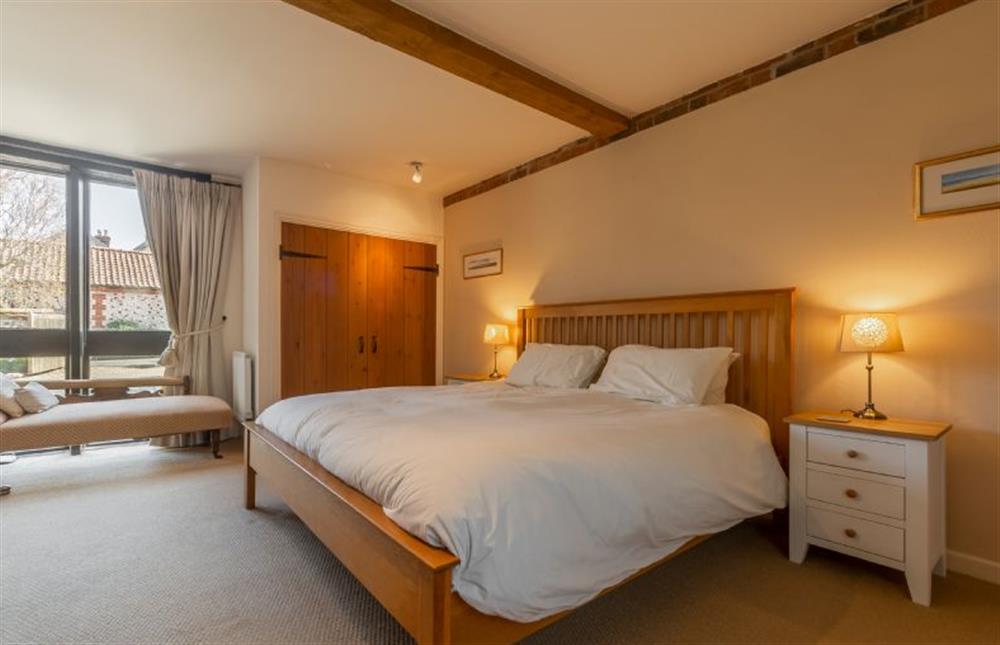 Ground floor: Master bedroom with super-king size bed (photo 2) at Oyster Barn, Titchwell near Kings Lynn