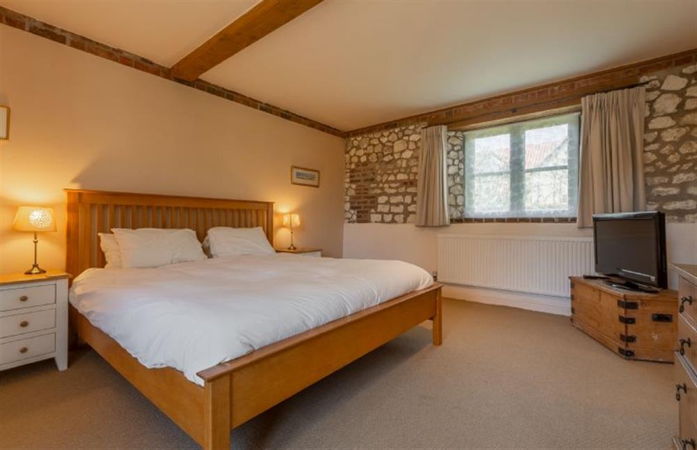 Ground floor: Master bedroom with super-king size bed at Oyster Barn, Titchwell near Kings Lynn