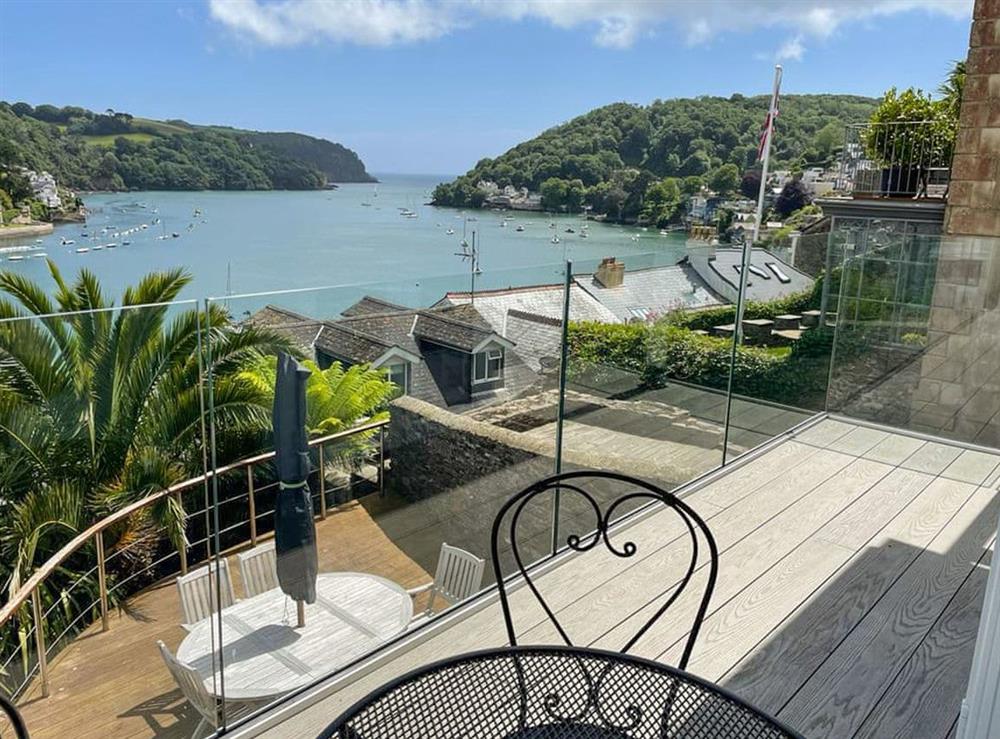 Water views over the decked balcony from the bedroom at Oystercatcher  in Dartmouth, Devon