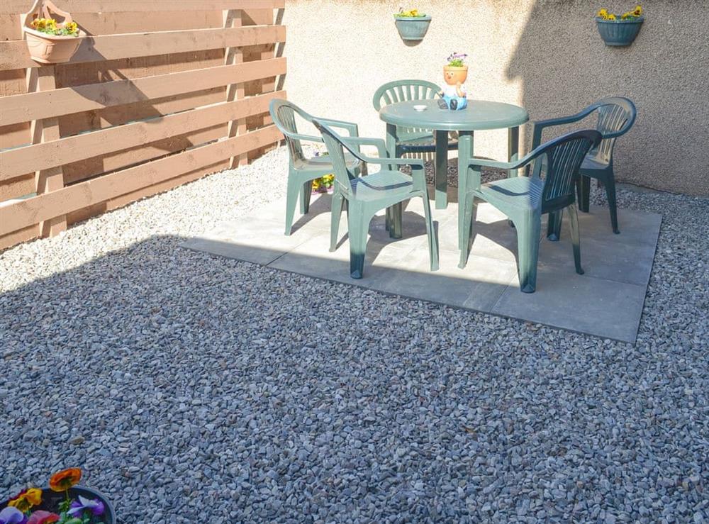 Enclosed courtyard with outdoor furniture at Oystercatcher in Embo, near Dornoch, Highlands, Sutherland