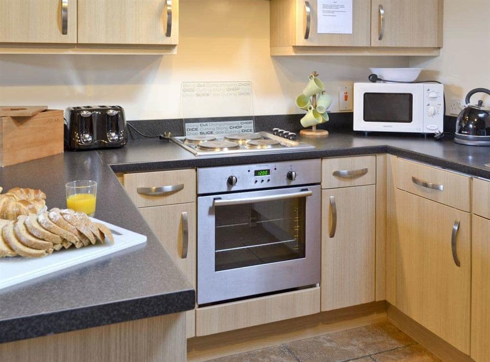 Well-equipped fitted kitchen at Padgett Lodge in Muston, Filey, North Yorkshire