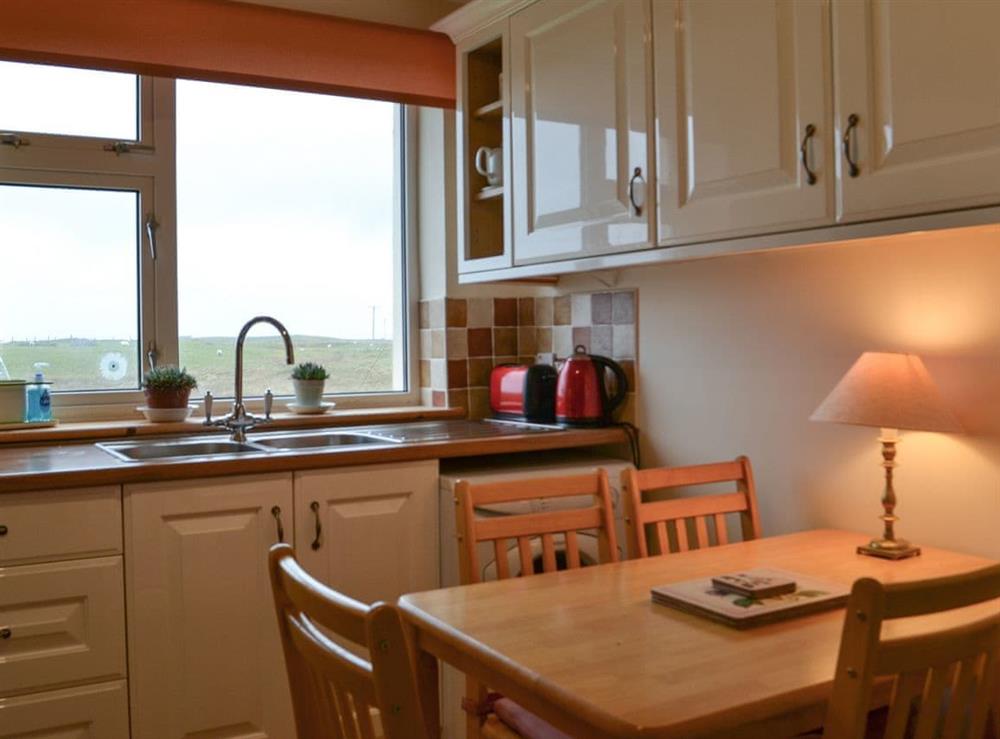 Kitchen with dining area at Padraigs Cottage in Howbeg (Tobha Beag), Isle of South Uist, Scotland