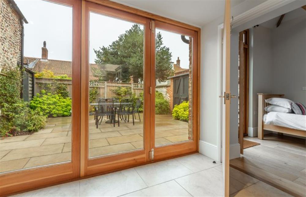 Ground floor: Bi-fold doors into courtyard, and bedroom two at Palgrave Barn, Burnham Market near Kings Lynn