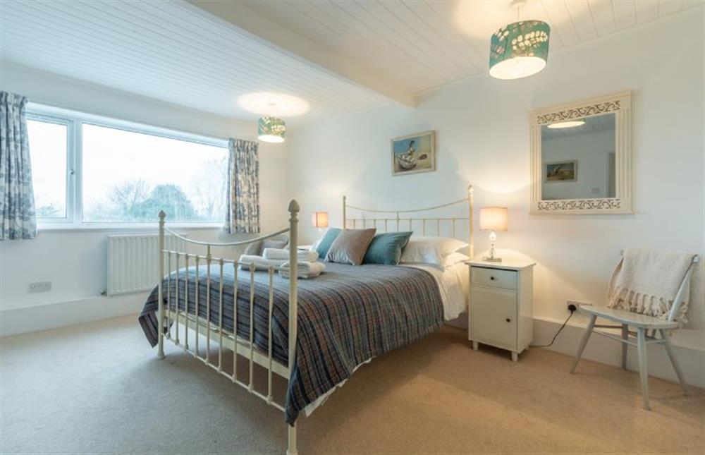 Bedroom one with 5’ king-size bed at Palm Trees, Polzeath