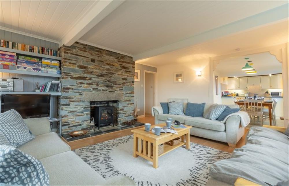 Sitting room with feature fireplace and electric fire and delightful balcony at Palm Trees, Polzeath