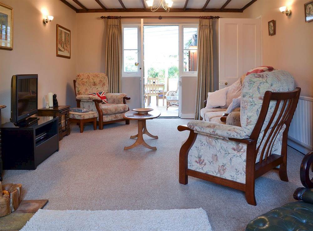 Charming beamed living room with access to conservatory at Pams Plaice in Offord D’Arcy, near Godmanchester, Cambridgeshire, England
