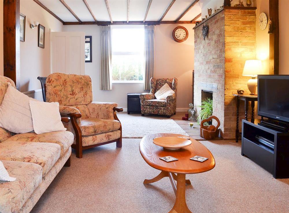 Living room with feature brickwork fireplace at Pams Plaice in Offord D’Arcy, near Godmanchester, Cambridgeshire, England