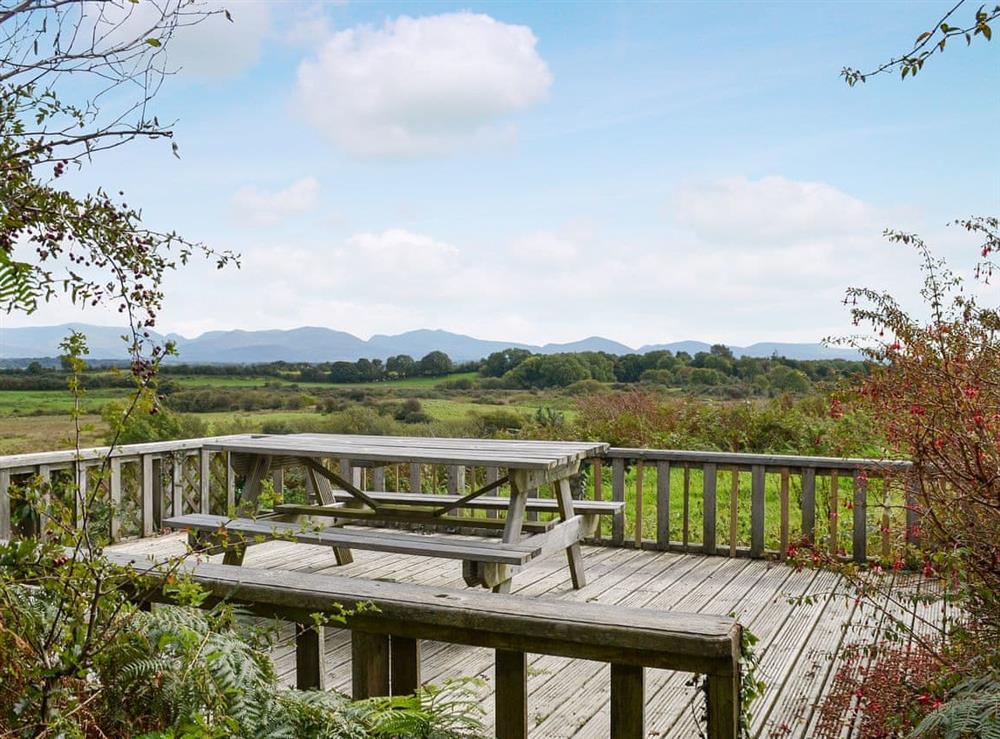 Lovely decked area, a perfect spot to admire the far-reaching views across to the mountains of Snowdonia at Pant Y Mel in Llanbedrgoch, near Benllech, Anglesey, Gwynedd
