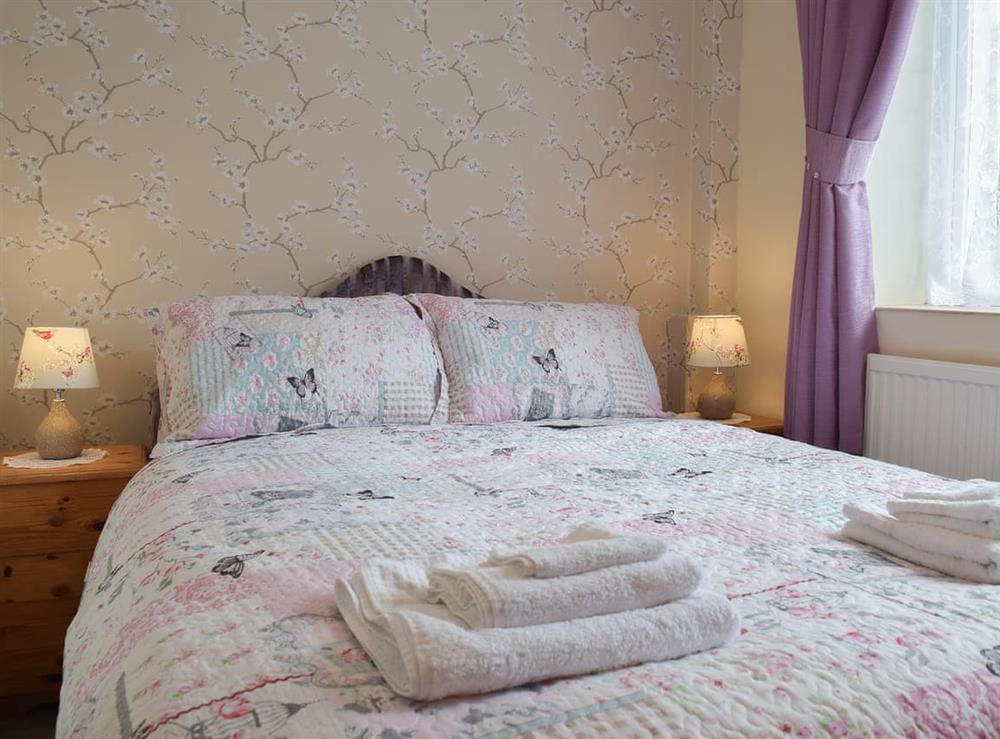 Warm and welcoming double bedroom at Lower Mill Barn, 