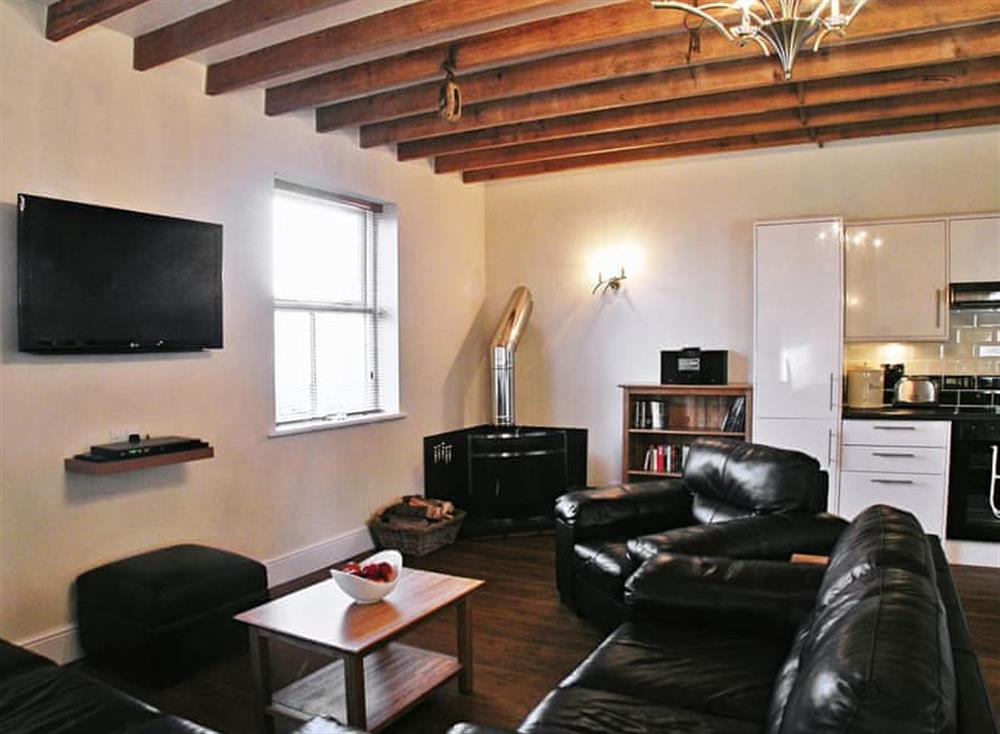 Comfortable living area with wood burner at Parc Y Bryn Lodge in Broadlay, near Ferryside, Dyfed
