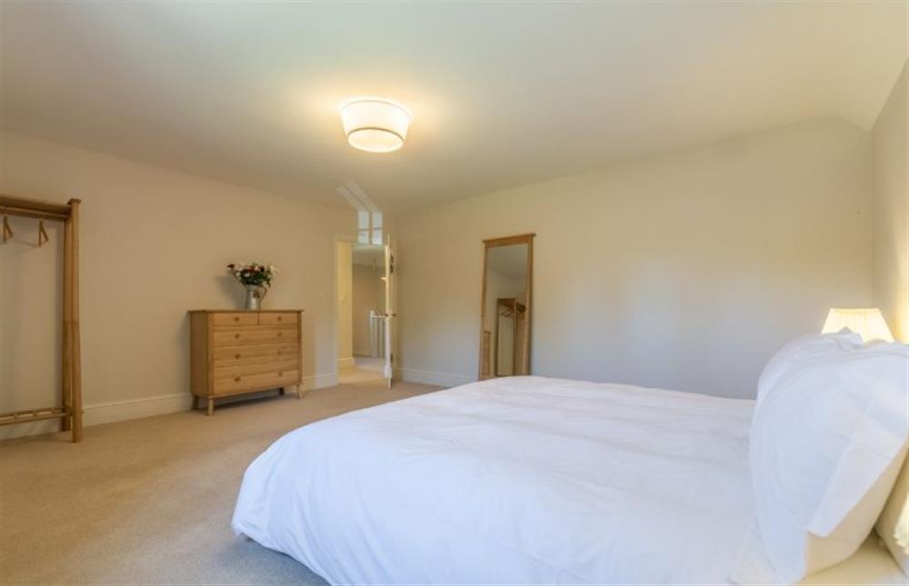 First floor: Master bedroom with chest of drawers and hanging rail at Park Cottage, Fring near Kings Lynn