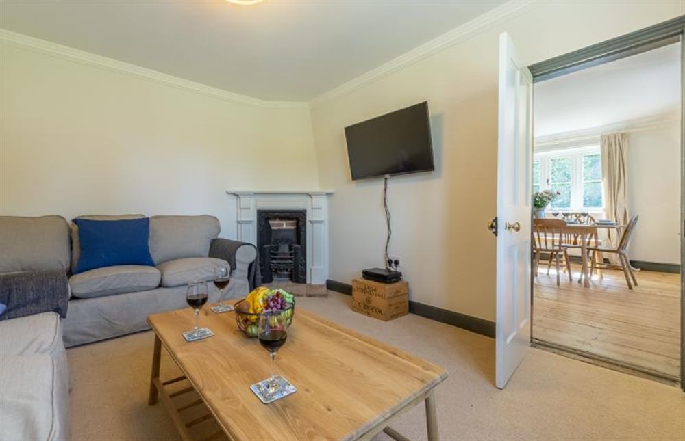 Ground floor: Sitting room with wall mounted flatscreen television at Park Cottage, Fring near Kings Lynn