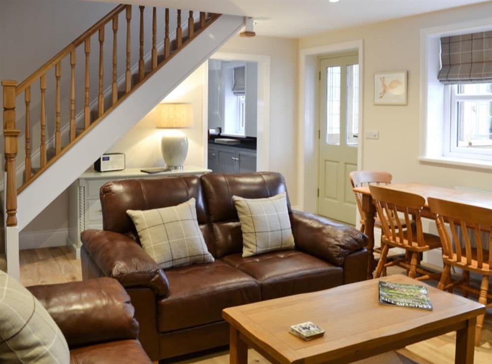 Cosy living room with dining area (photo 2) at Park Farm Cottage in Flixton, near Filey, North Yorkshire