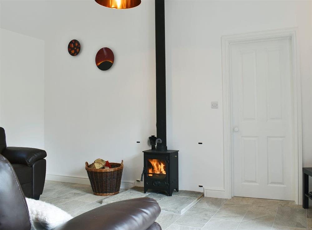 Light and airy living area with wood burner at Park Hill Barn in Woolaston, near Chepstow, Gloucestershire