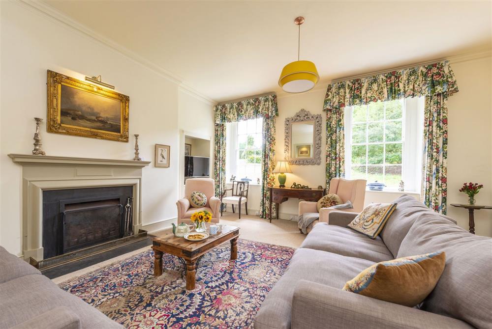 Ground floor sitting room with open fire at Park House, Winterborne Came