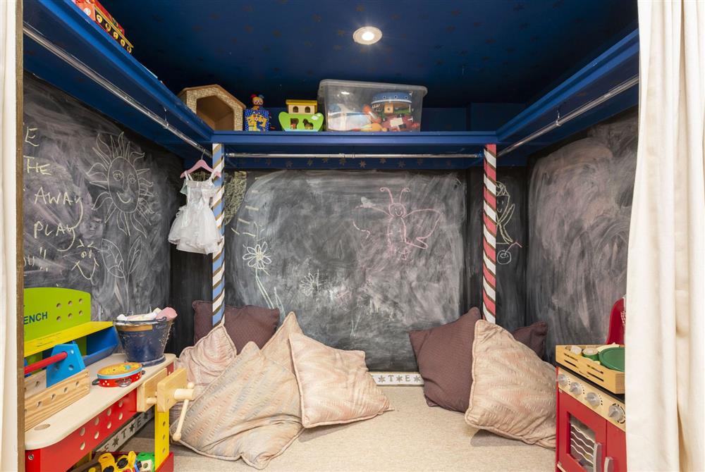 Second floor children’s’ play area with chalk board walls, toys and games