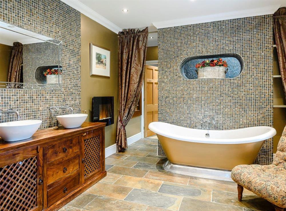 Impressive en-suite with roll-top bath and walk-in shower