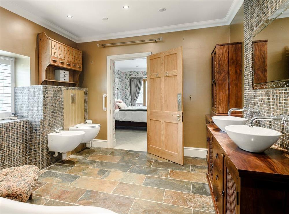 Impressive en-suite with roll-top bath and walk-in shower