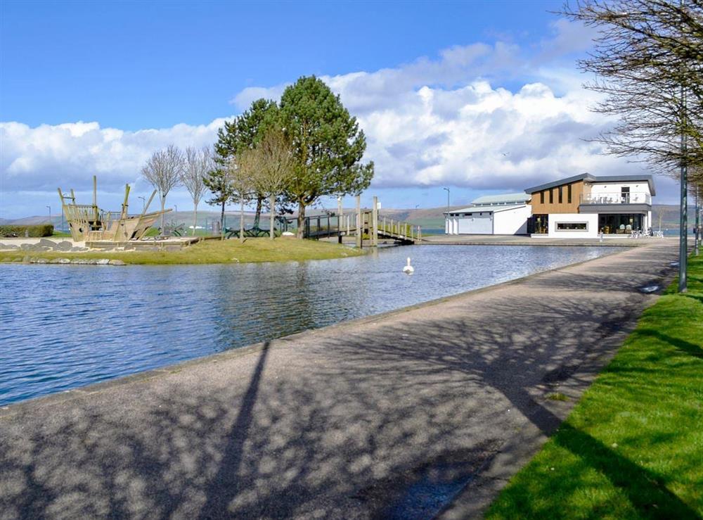 Agnew Park with a pond, café and the sea beyond at Park View Cottage in Stranraer, Dumfries and Galloway, Wigtownshire