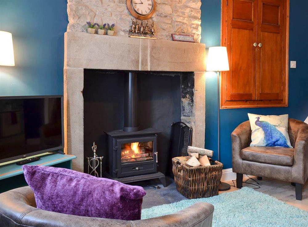 Cosy living/dining room with wood burner at Parsley Cottage in Tideswell, near Buxton, Derbyshire
