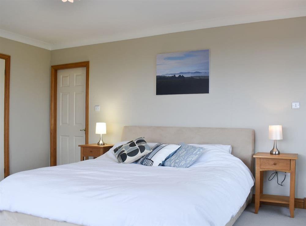 Welcoming bedroom with super kingsize bed at Pathacres in Colwyn Bay, Clwyd