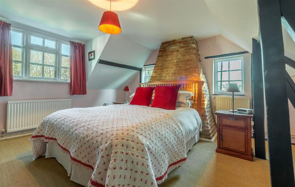 Master bedroom with 5’ king-size bed at Peak Hill Cottage, Theberton