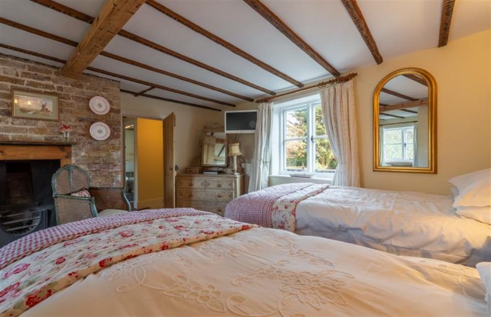 Bedroom two with feature fireplace at Pear Tree Cottage, Blakeney near Holt