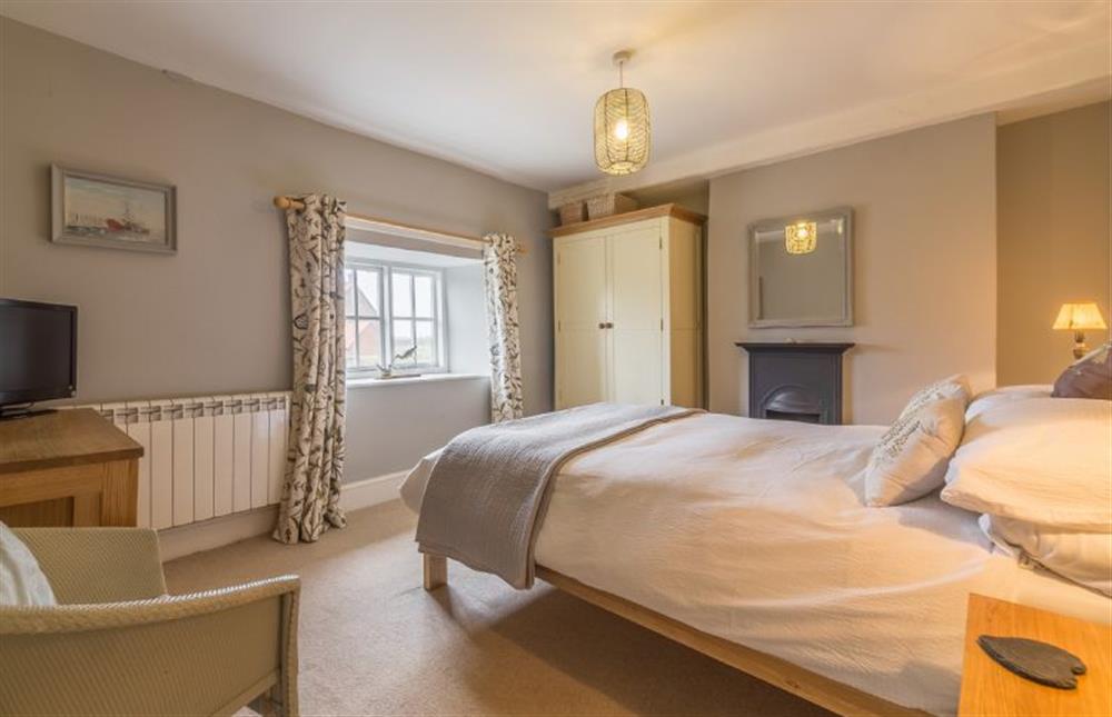 First floor: Master bedroom with feature fireplace at Pear Tree Cottage, Holme-next-the-Sea near Hunstanton