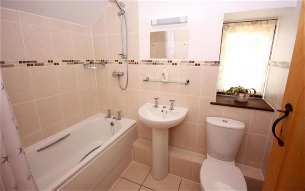 The family bathroom, with shower over bath - first floor at Pear Tree Cottage in Honiton