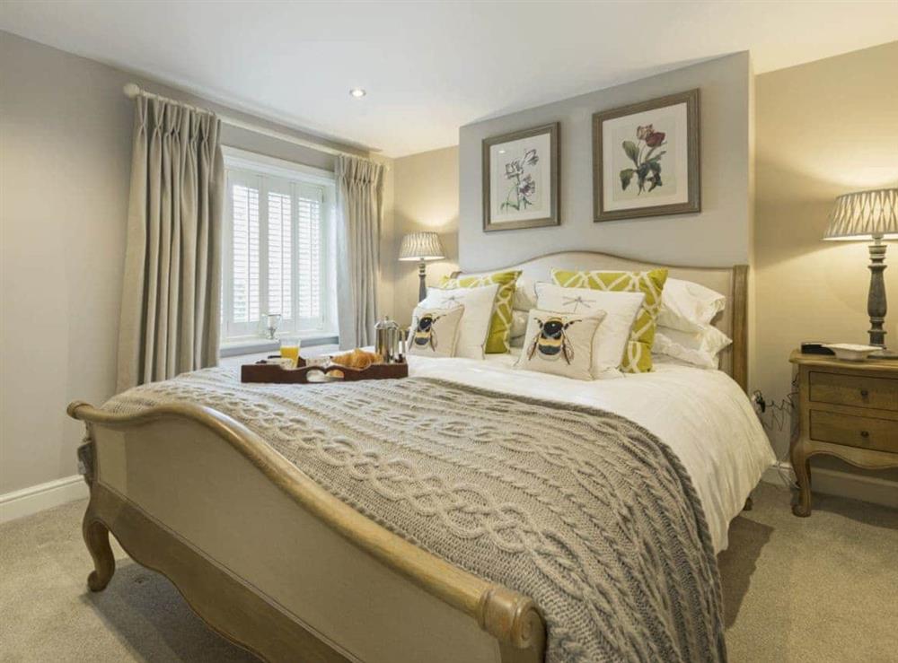 Beautifully decorated double bedroom with kingsize bed at Pear Tree Cottage in Louth, Lincolnshire, England