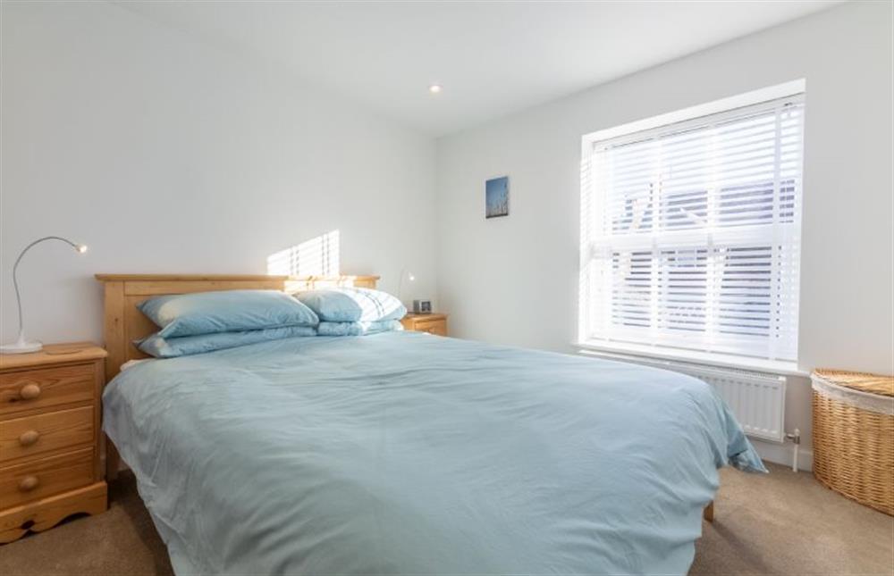 First floor: Bedroom two, king size bed at Pebble Cottage, Brancaster Staithe near Kings Lynn