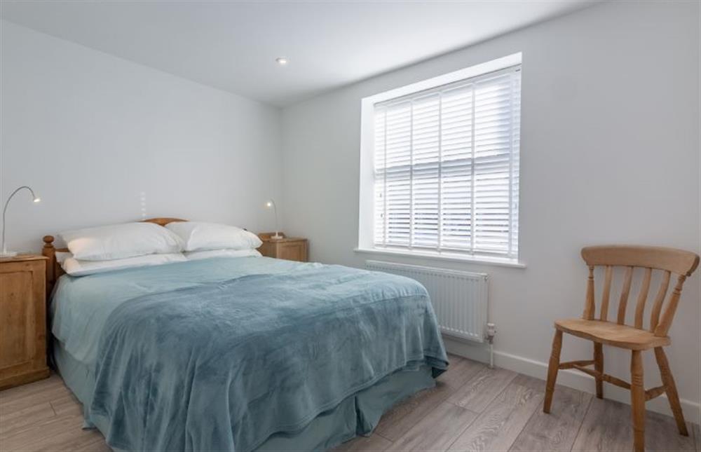 Ground floor: Master bedroom has king size bed at Pebble Cottage, Brancaster Staithe near Kings Lynn