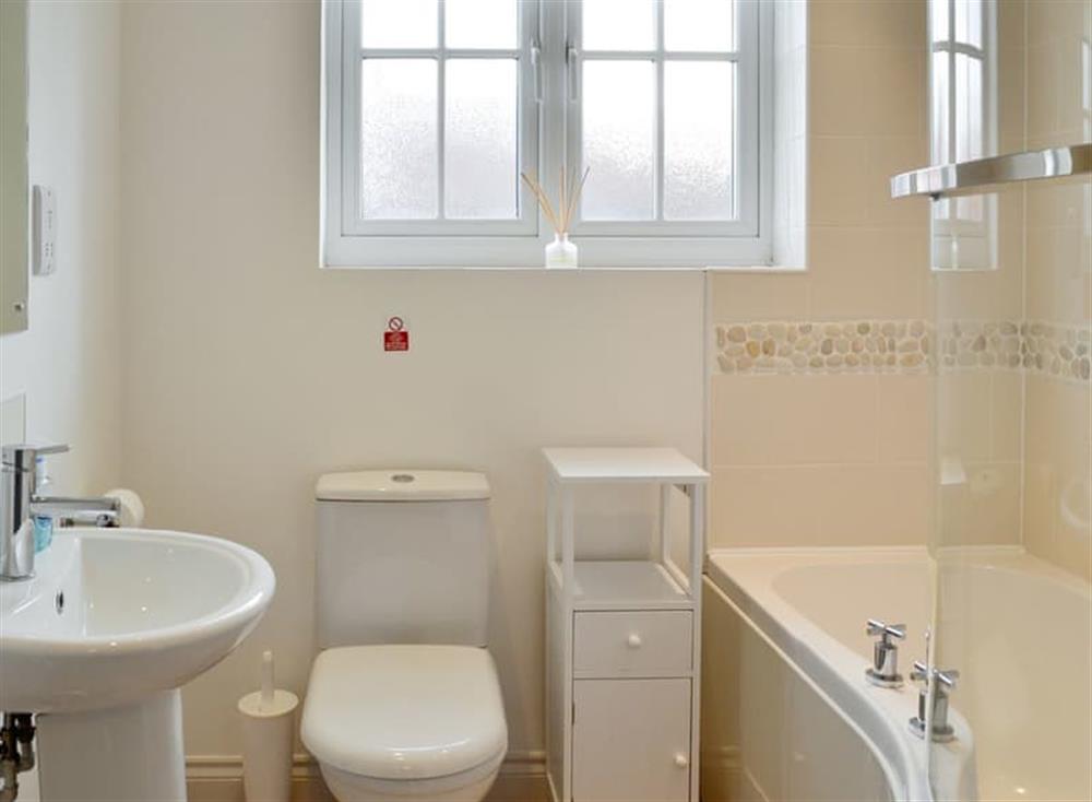Family bathroom with shower over bath at Pebble Cottage in Near Filey, North Yorkshire
