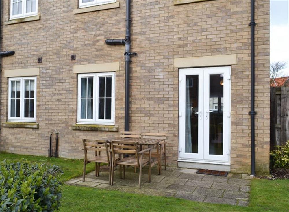 Patio area with outdoor furniture at Pebble Cottage in Near Filey, North Yorkshire