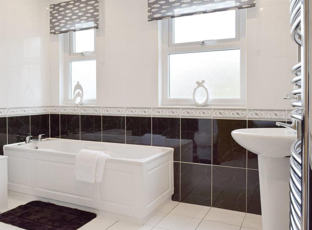 Family bathroom with Jacuzzi bath and separate shower cubicle at Pebble Reach in Amroth, near Saundersfoot, Pembrokeshire, Dyfed