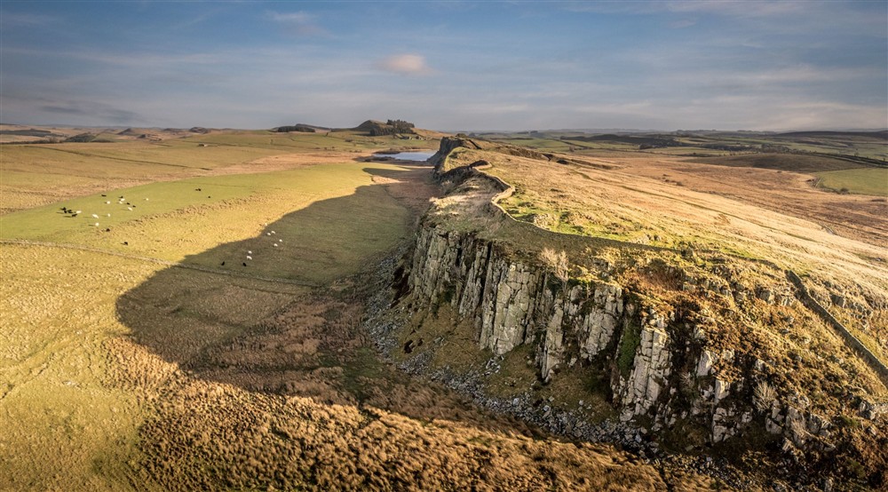 An aerial view showing Hadrians Wall, running towards Crag Lough and the Sycamore Gap, near Peel Cottage, Northumberland at Peel Cottage in Hexham, Northumberland
