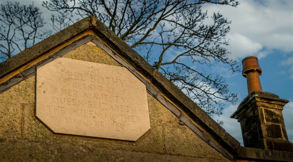 The plaque above the door, detailing the opening of Peel Cottage by the Queen Mother in 1989, Northumberland at Peel Cottage in Hexham, Northumberland